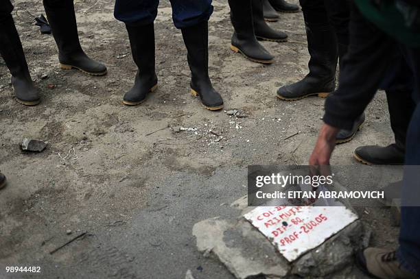 Worker of Anglo Gold Ashanti mining company points at an exploration shaft at La Colosa deposit in Cajamarca, department of Tolima, 250 km west of...