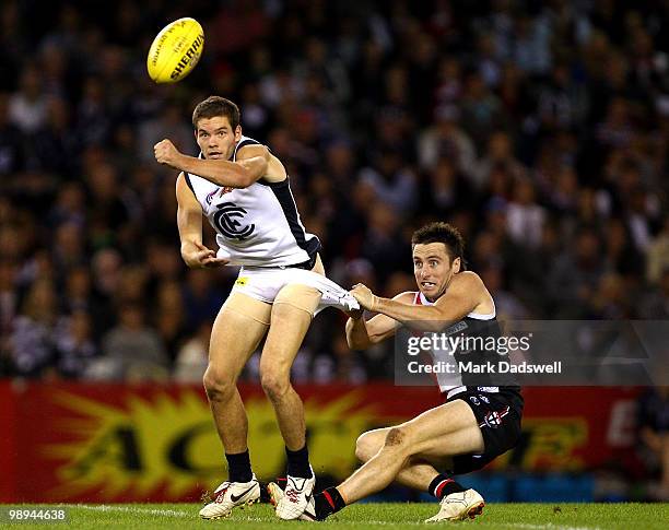 Aaron Joseph of the Blues handballs as he is tackled by Stephen Milne of the Saints during the round seven AFL match between the St Kilda Saints and...