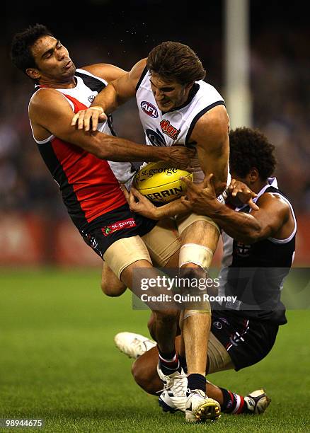 Jarrad Waite of the Blues is tackled by Raphael Clarke and James Gwilt of the Saints during the round seven AFL match between the St Kilda Saints and...