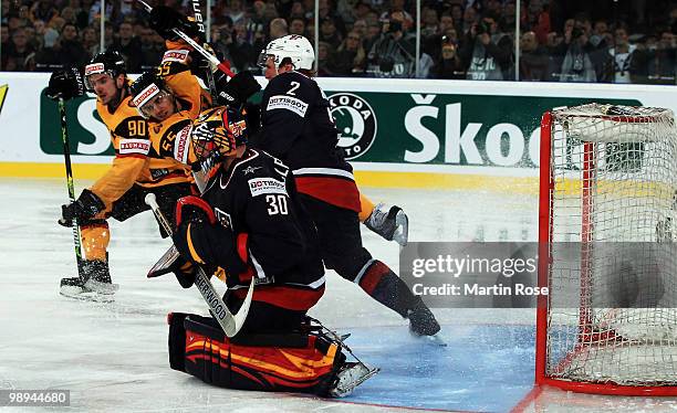 Matt Greene of USA blocks Felix Schutz of Germany during the IIHF World Championship Group D match between USA and Germany at Veltins Arena on May 7,...