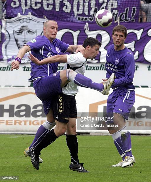 Tobias Nickenig of VfL Osnabrueck and Bjoern Hertl of SV Wacker Burghausen battle for the ball during the Third League match between Wacker...