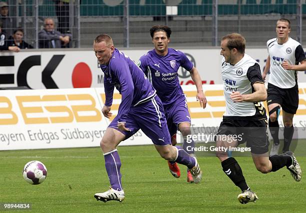 Aleksandar Kotuljac of VfL Osnabrueck, Bjoern Lindemann of VfL Osnabrueck and Patrick Kirsch of SV Wacker Burghausen battle for the ball during the...