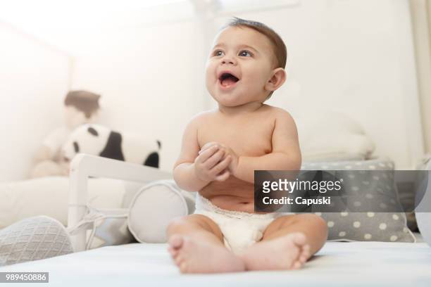 cute baby using diapers - diaper stock pictures, royalty-free photos & images