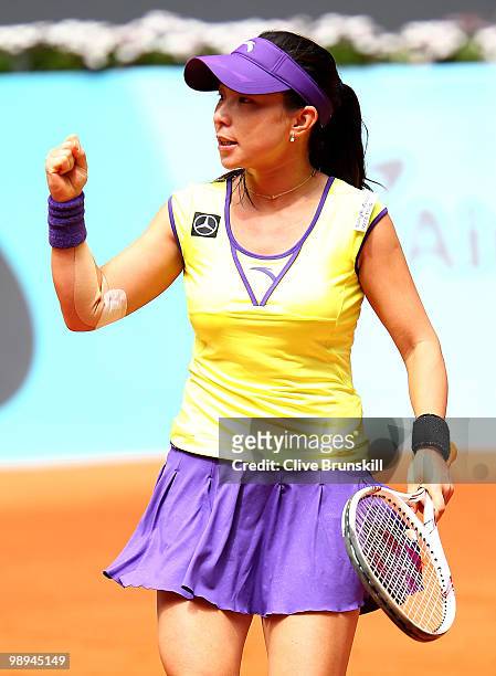 Jie Zheng of China celebrates a point against Anabel Medina Garrigues of Spain in their first round match during the Mutua Madrilena Madrid Open...