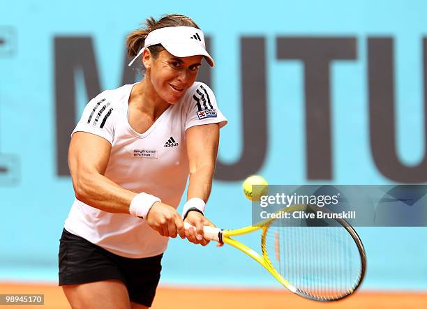 Anabel Medina Garrigues of Spain plays a backhand against Jie Zheng of China in their first round match during the Mutua Madrilena Madrid Open tennis...