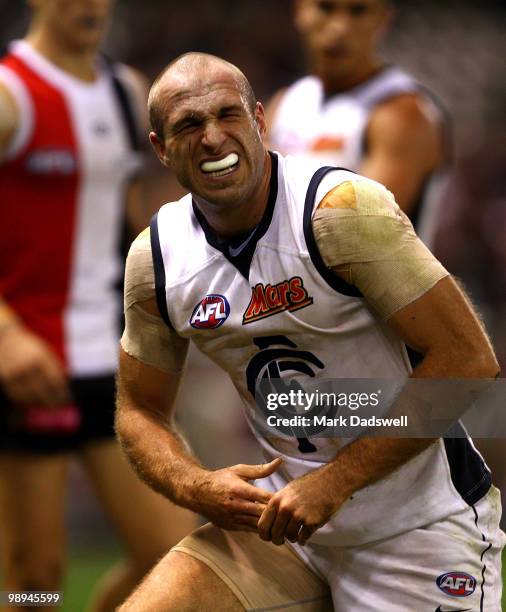 Chris Judd of the Blues grimaces in pain with a dislocated finger during the round seven AFL match between the St Kilda Saints and the Carlton Blues...