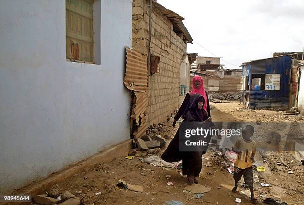 Somali refugees walk in the Basateen slum near the Yemeni southern port city of Aden on February 11, 2010. Hundreds of thousands of Somali refugees...