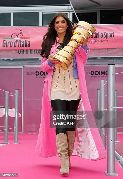 Dutch actress Yolanthe Cabau carries the Giro d'Italia trophy as riders competed in the 3rd stage of the 93rd Giro d'Italia, from Amsterdam to...