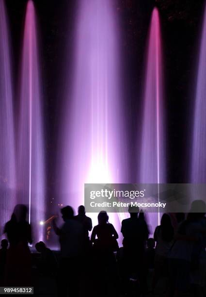 people wondering colourful fountain in budapest, hungary - exhibition people stock pictures, royalty-free photos & images