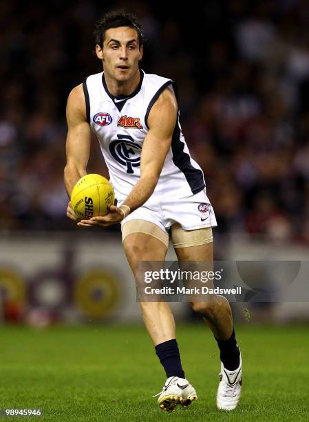 Kane Lucas of the Blues handballs during the round seven AFL match between the St Kilda Saints and the Carlton Blues at Etihad Stadium on May 10,...