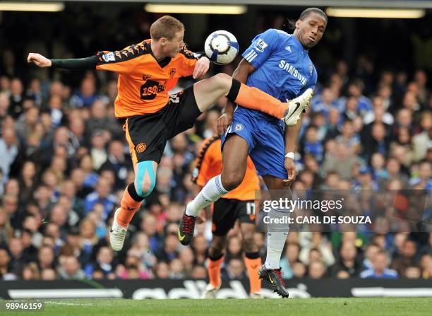 Chelsea's Ivorian striker Didier Drogba vies with Wigan's Scottish midfielder James McCarthy during the English Premier League football match between...