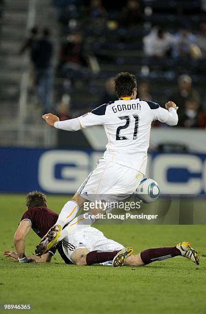 Alan Gordon of the Los Angeles Galaxy trips over Drew Moor of the Colorado Rapids at Dick's Sporting Goods Park on May 5, 2010 in Commerce City,...