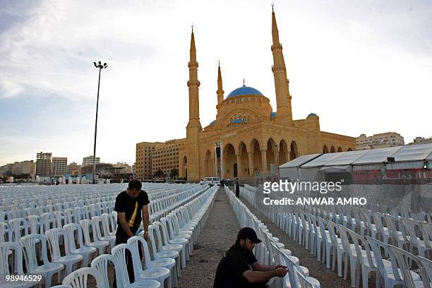 Workers set chairs opposite the Mohammed al-Amin mosque in the Lebanese capital Beirut on February 11, 2010 ahead of a mass rally on February 14 to...