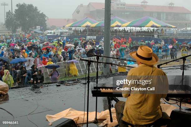 Jon Cleary performs in the pouring rain at the Gentilly Stage on day one of New Orleans Jazz & Heritage Festival on April 23, 2010 in New Orleans,...