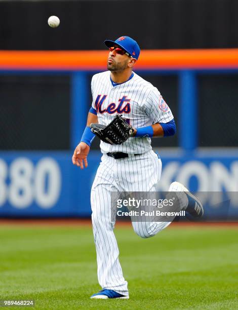 Jose Bautista of the New York Mets trots in to make a basket catch on a fly ball ball hit by Enrique Hernandez in the third inning in an MLB baseball...