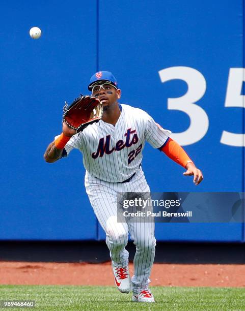 Dominic Smith of the New York Mets catches a fly ball to left field for an out in an MLB baseball game against the Los Angeles Dodgers on June 24,...