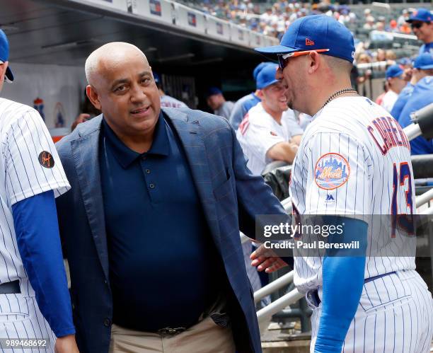 Former New York Mets Manager Omar Minaya walks through the dugout and talks with Asdrubal Cabrera of the New York Mets before an MLB baseball game...