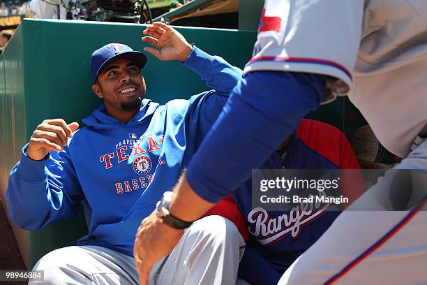 Nelson Cruz of the Texas Rangers jokes with teammates in the dugout before the game between the Texas Rangers and the Oakland Athletics on Wednesday,...