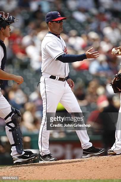 Manager Manny Acta of the Cleveland Indians makes a pitching change during the game between the Toronto Blue Jays and the Cleveland Indians on...