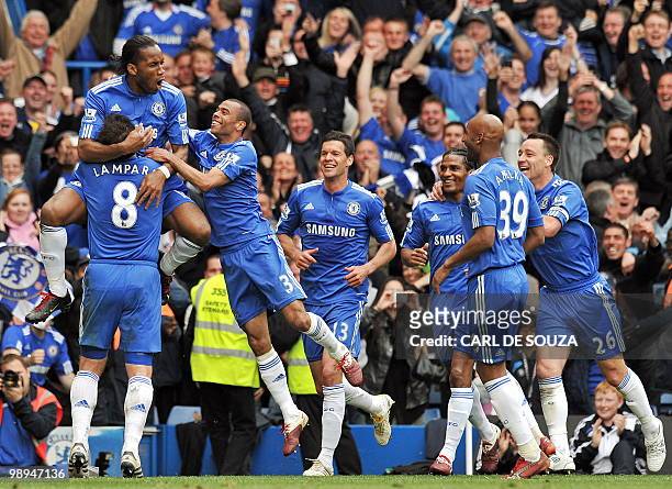 Chelsea's Ivorian striker Didier Drogba celebrates scoring the fifth goal with team-mates during the English Premier League football match between...