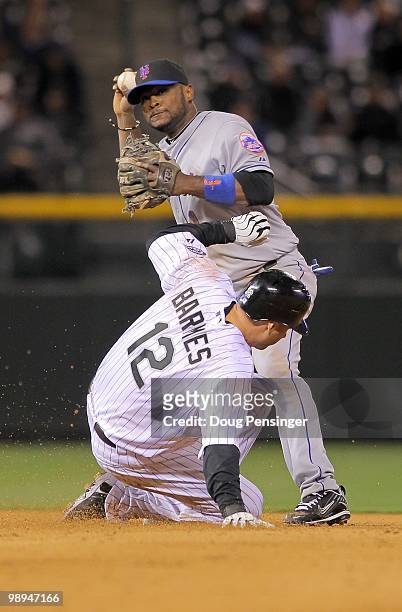 Second baseman Luis Castillo of the New York Mets turns a double play over Clint Barmes of the Colorado Rockies during Major League Baseball action...
