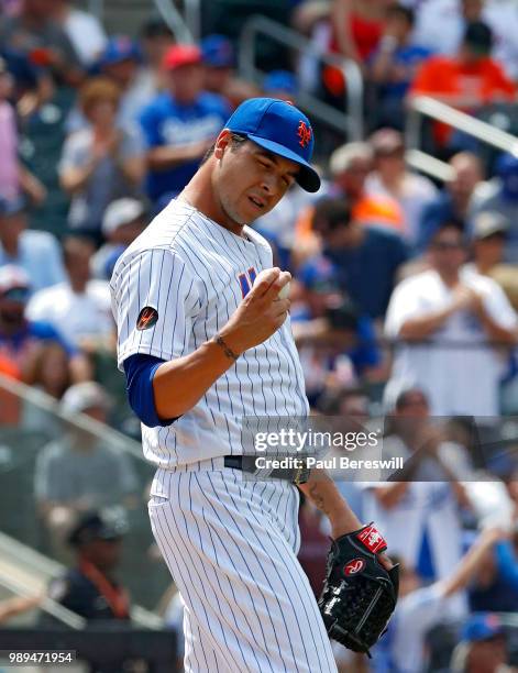 Pitcher Anthony Swarzak of the New York Mets stares at the baseball after giving up a home run to Joc Pederson in the 7th inning in an MLB baseball...