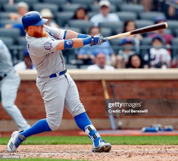 Justin Turner of the Los Angeles Dodgers hits the go ahead home run in the 11th inning in an MLB baseball game against the Los Angeles Dodgers on...