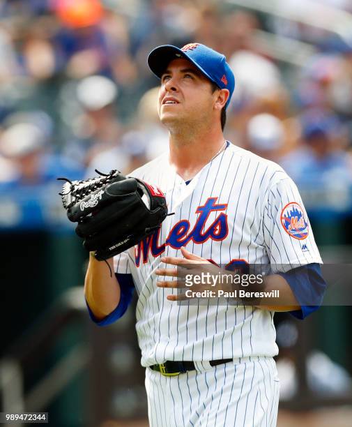 Relief pitcher Anthony Swarzak of the New York Mets reacts as he walks back to the dugout after ending the 8th inning in an MLB baseball game against...