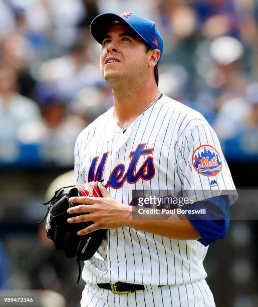 Relief pitcher Anthony Swarzak of the New York Mets reacts as he walks back to the dugout after ending the 8th inning in an MLB baseball game against...