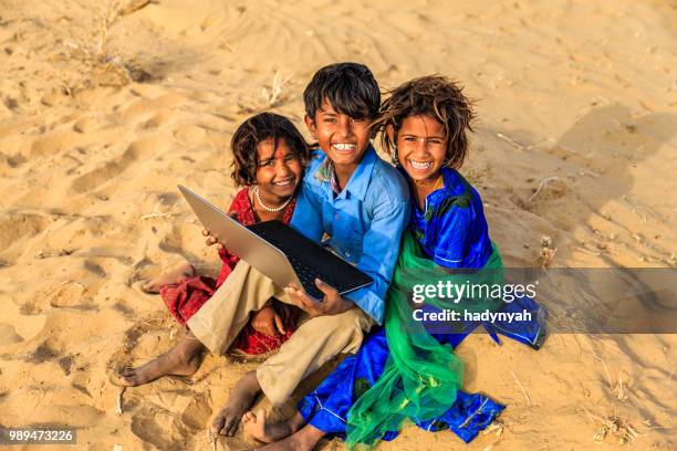 group of happy gypsy indian children using laptop, india - laptop desert stock pictures, royalty-free photos & images