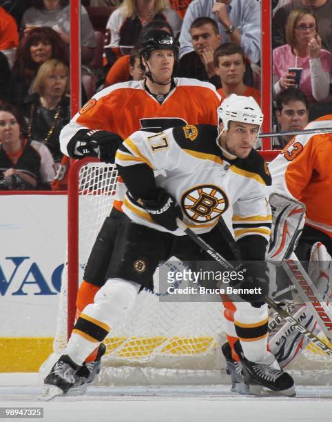 Milan Lucic of the Boston Bruins skates against Chris Pronger of the Philadelphia Flyers in Game Four of the Eastern Conference Semifinals during the...