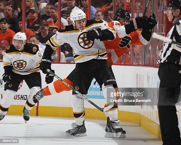 Milan Lucic of the Boston Bruins hits Scott Hartnell of the Philadelphia Flyers in Game Four of the Eastern Conference Semifinals during the 2010 NHL...