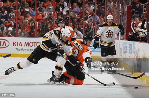 Milan Lucic of the Boston Bruins skates against Dan Carcillo of the Philadelphia Flyers in Game Four of the Eastern Conference Semifinals during the...