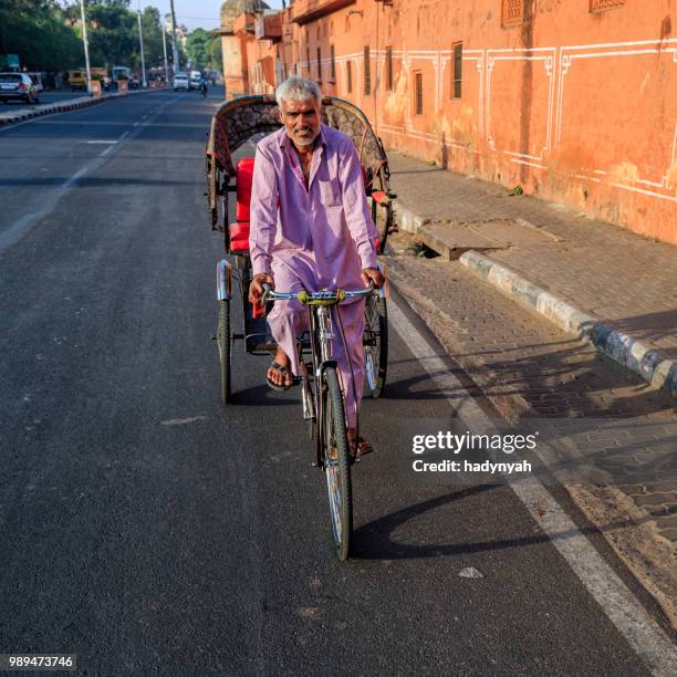 indian men ride cycle rickshaw, india - rickshaw driver stock pictures, royalty-free photos & images