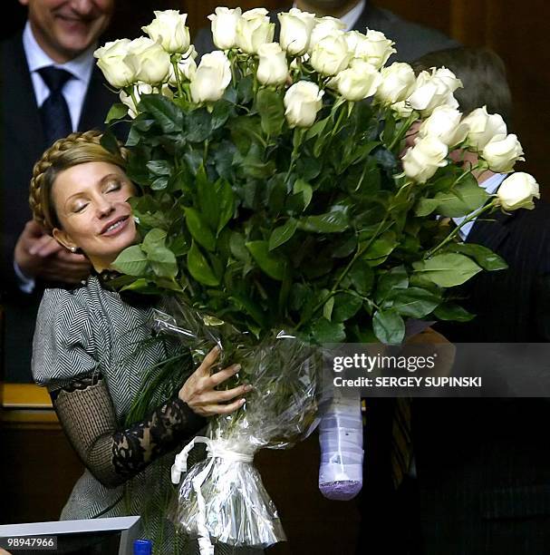 Yulia Timoshenko holds a flowers as she celebrates after Parliament confirmed her as Prime minister of Ukraine in Kiev 04 February, 2005. The...