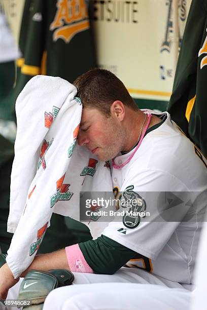 Landon Powell of the Oakland Athletics wipes off with a towel in the dugout during the game between the Tampa Bay Rays and the Oakland Athletics on...
