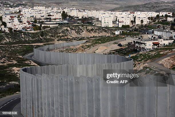 View of the controversial Israeli separation barrier on the outskirts of Jerusalem on February 10, 2010. On the left the Israeli settlement of Pisgat...