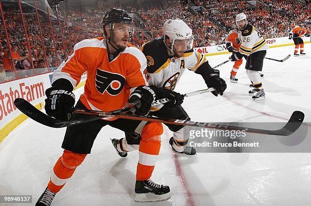 Lukas Krajicek of the Philadelphia Flyers skates against Patrice Bergeron of the Boston Bruins in Game Four of the Eastern Conference Semifinals...
