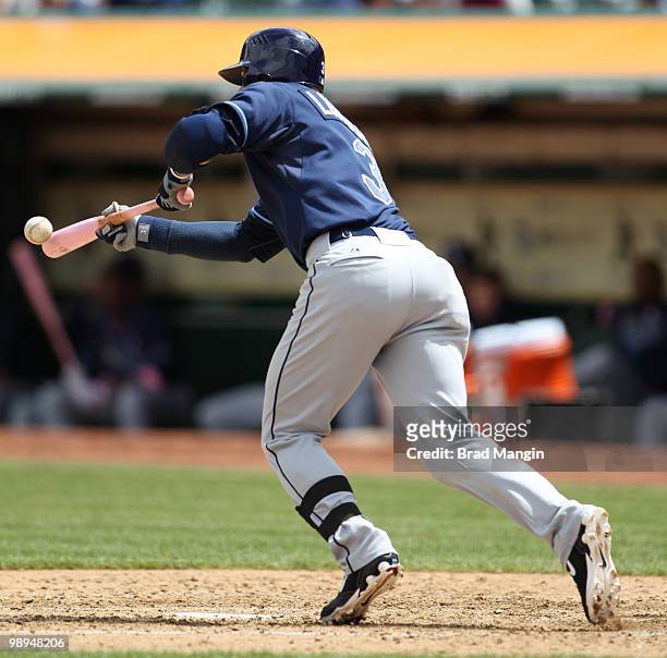 Evan Longoria of the Tampa Bay Rays bunts during the game between the Tampa Bay Rays and the Oakland Athletics on Sunday, May 9 at the Oakland...