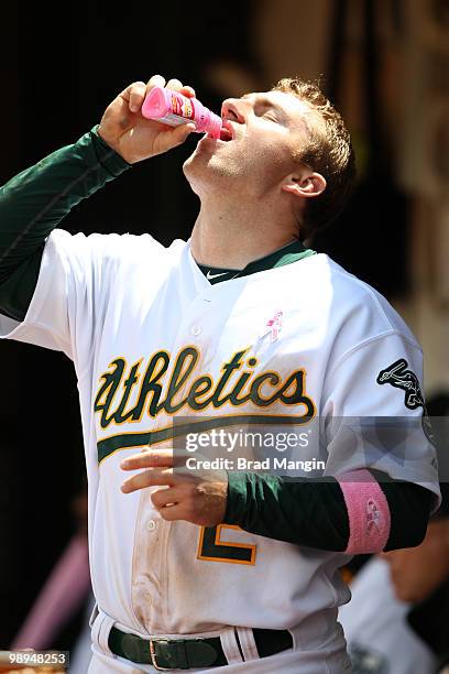 Cliff Pennington of the Oakland Athletics drinks Pepto-Bismol in the dugout during the game between the Tampa Bay Rays and the Oakland Athletics on...