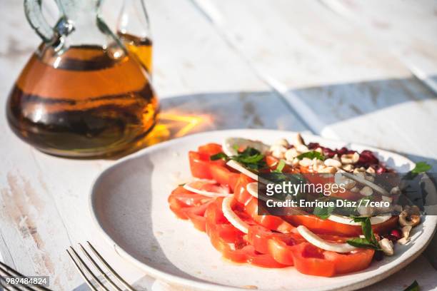 heirloom raf tomato salad with fresh walnut oil close up - raw food diet stock pictures, royalty-free photos & images