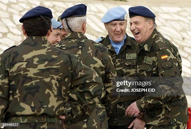 Spain's King Juan Carlos , in full military uniform, and UNIFIL commander Alberto Asarta Cuevas share a light moment with officers serving with the...