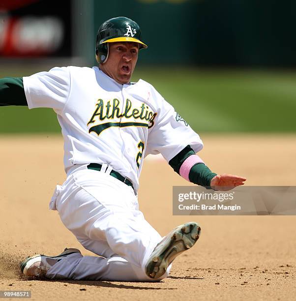 Cliff Pennington of the Oakland Athletics slides into third base during the game between the Tampa Bay Rays and the Oakland Athletics on Sunday, May...