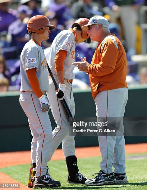Head coach Augie Garrido of the Texas Longhorns talks with batter Brandon Loy during a game against the Kansas State Wildcats at Tointon Stadium on...