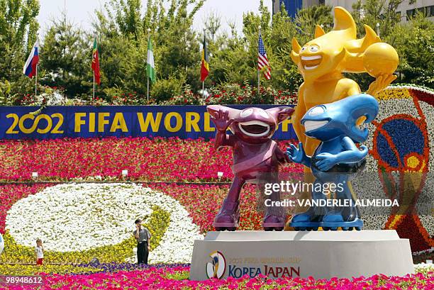 Man and a boy look the mascots of the World Cup Korea-Japan 2002 in front of the Suwon Stadium, 55 km south from Seoul, 25 May 2002. At Suwon Stadium...