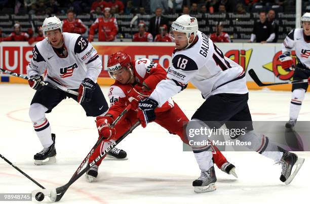 Galiardi of USA and Philip Larsen of Denmark battle for the puck during the IIHF World Championship group A match between USA and Denmark at Lanxess...