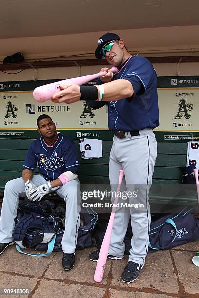 Willy Aybar and Evan Longoria of the Tampa Bay Rays get ready in the dugout before the game between the Tampa Bay Rays and the Oakland Athletics on...