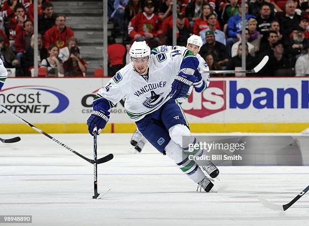 Alexander Burrows of the Vancouver Canucks grabs the puck at Game Two of the Western Conference Semifinals against the Chicago Blackhawks during the...