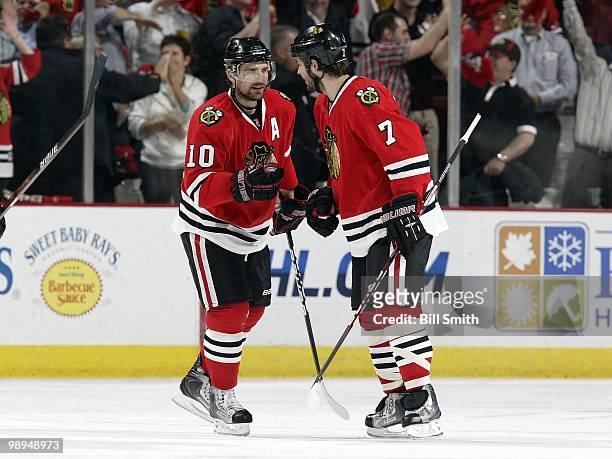 Patrick Sharp and Brent Seabrook of the Chicago Blackhawks celebrate after Sharp scores against the Vancouver Canucks at Game Two of the Western...