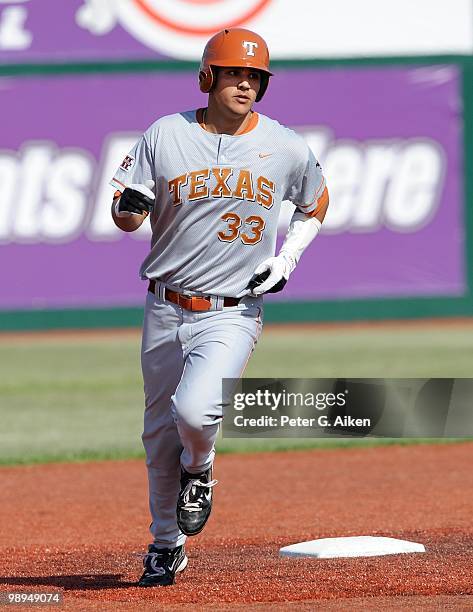 Left fielder Jonathan Walsh of the Texas Longhorns rounds second base after hitting a homerun during a game against the Kansas State Wildcats at...